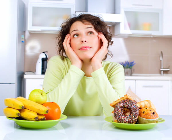 Hypnotherapy client debating whether to eat fruit or junk food